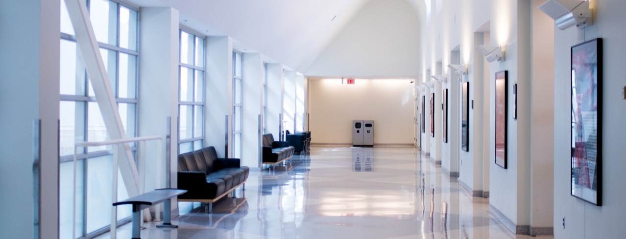 A long hallway with bright lighting and several benches