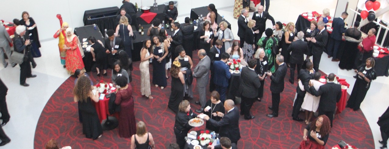 Guest are mingling at a cocktail reception in the Tangemann University Center atrium. 