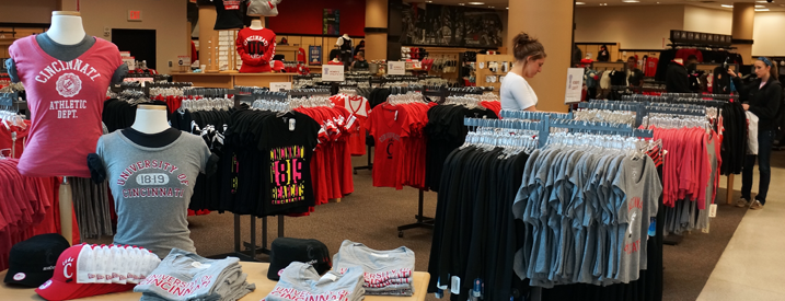 University of Cincinnati Bookstore with tables and racks of licensed UC product.