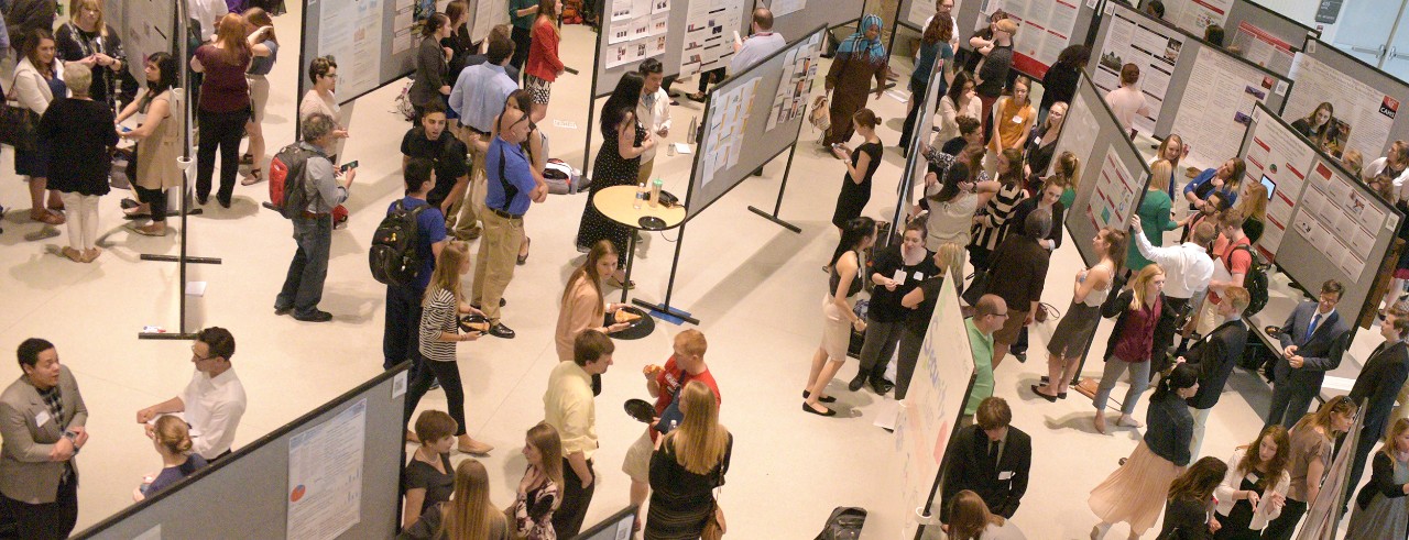Students and faculty view posters on exhibit in Great Hall