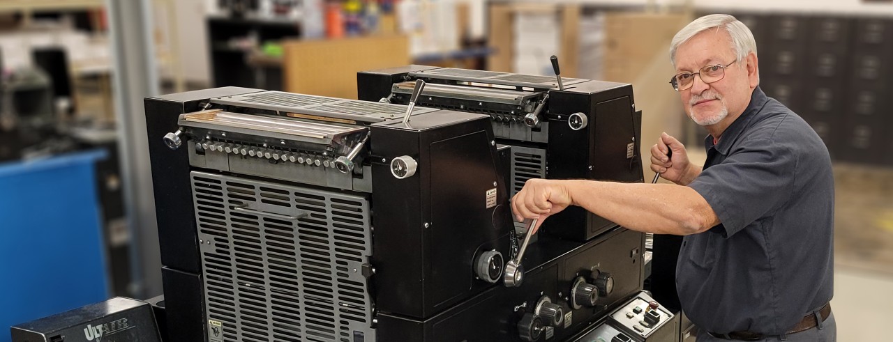 Printing operator prepares press for operation