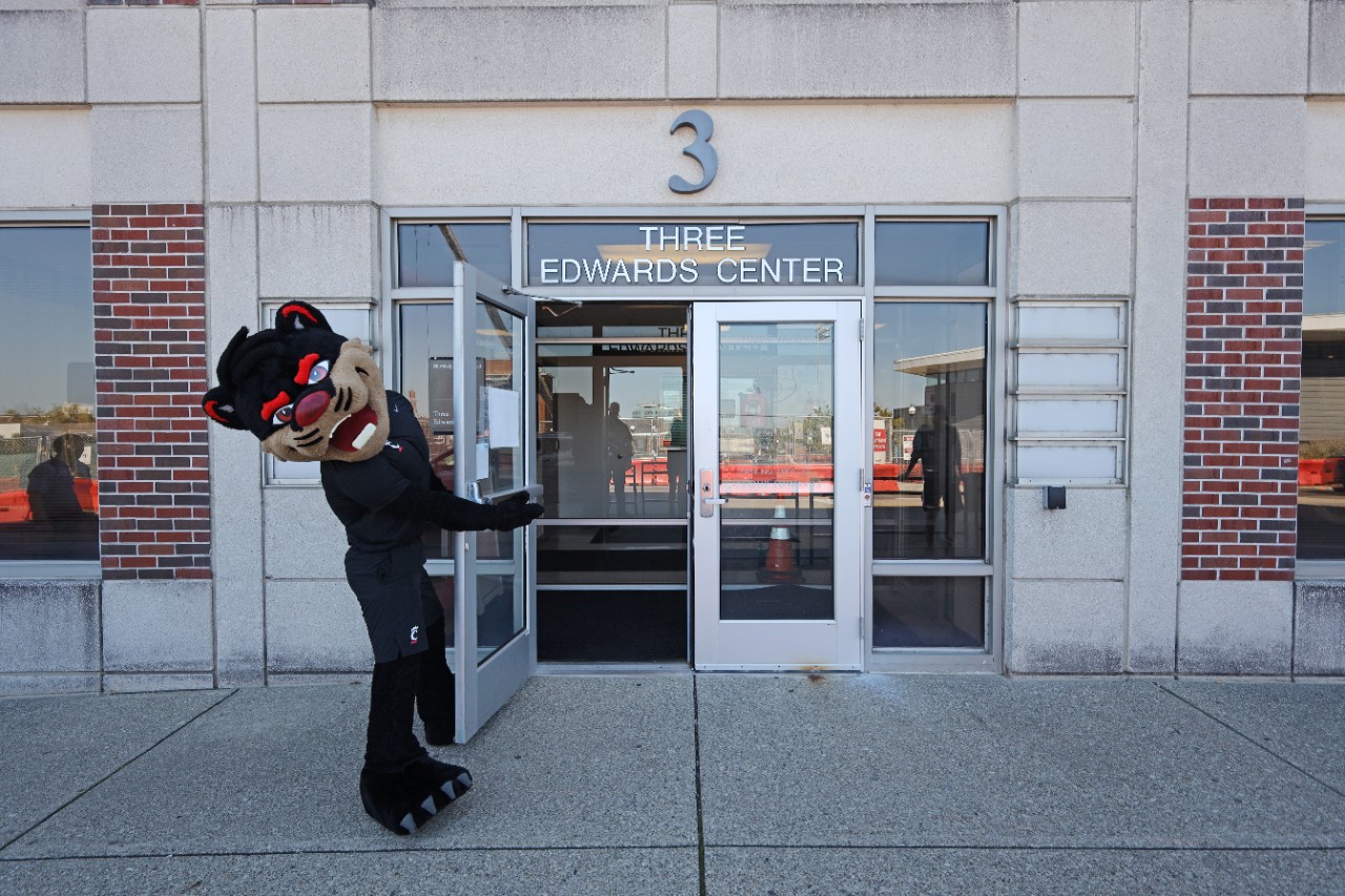 The Bearcat holds open the door to the Public Safety office.
