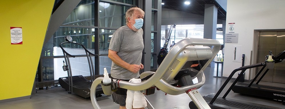 Older man exercising on treadmill.