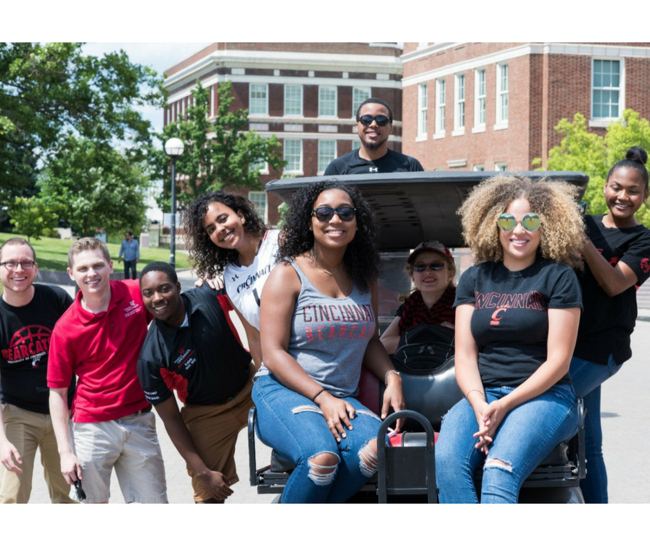 Group of students on a golf cart