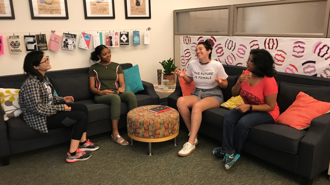 Students laughing and talking in the UC Women's Center lounge