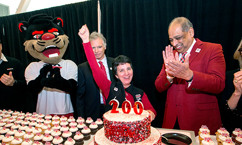 Kimberlee Dobbs celebrating UC's Bicentennial with President Pinto, and the Bearcat mascot