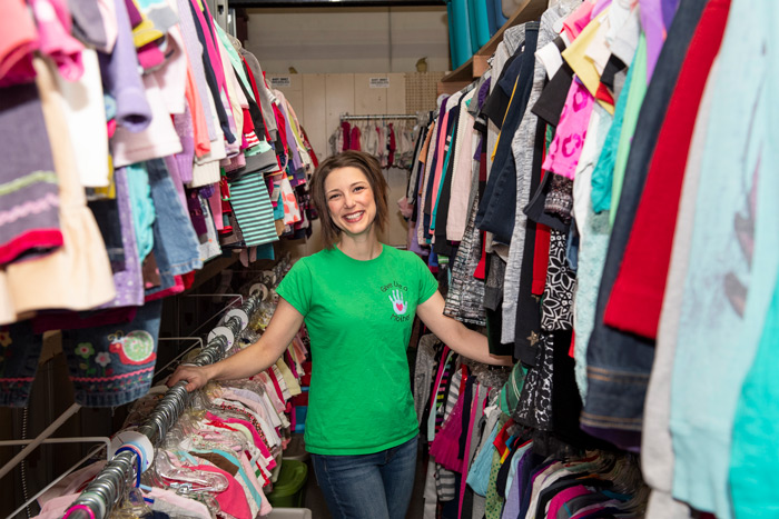 A volunteer from the Give like a Mother program arranges donated clothes