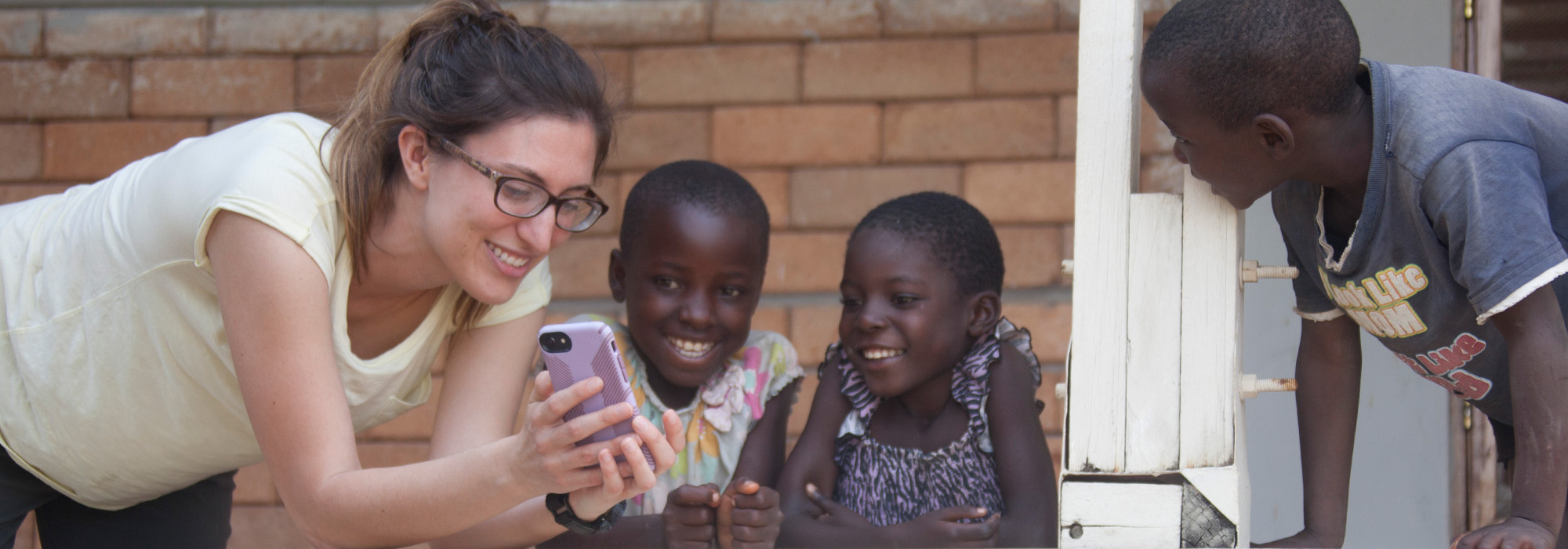 Med student Diandra Fortune shares photos from her phone with young children in Tanzania