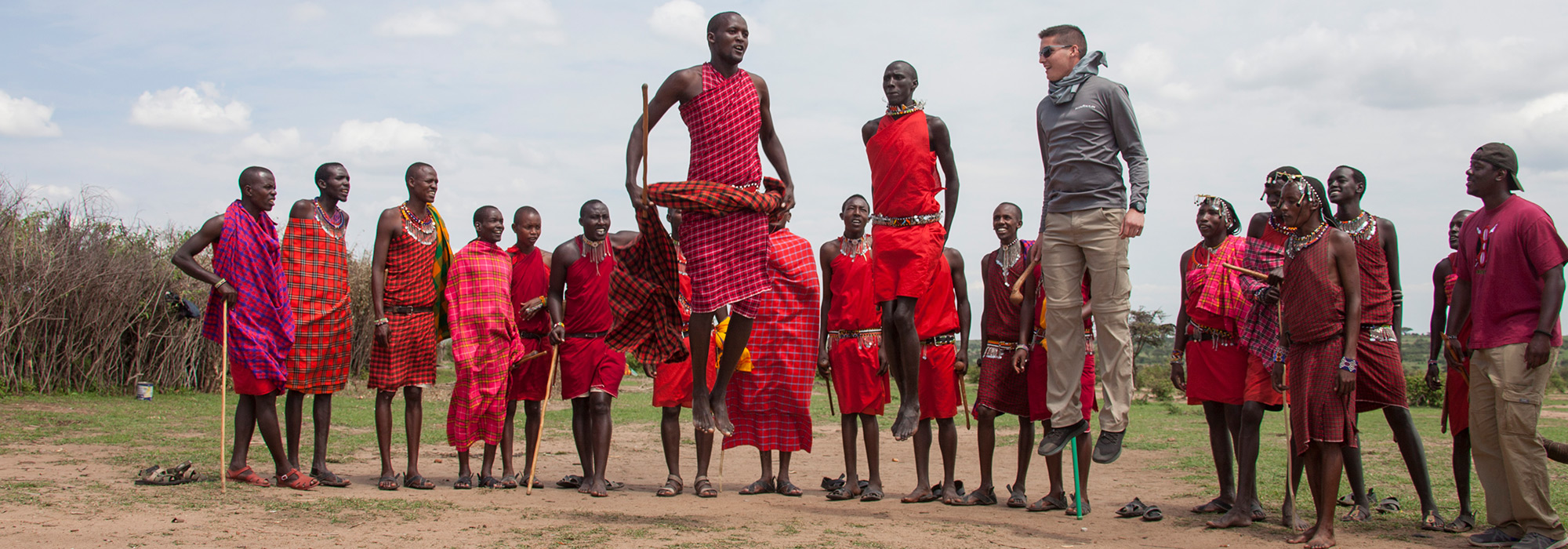 UC business student John Pancioli jumps with the Maasai people in a Maasai village in Kenya