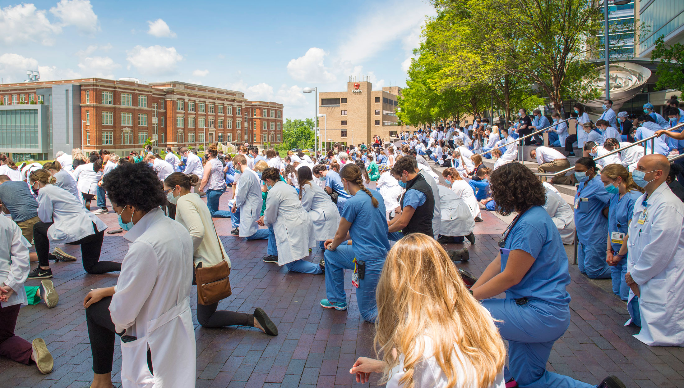 A group of UC Medical students and staff observe a moment of silence