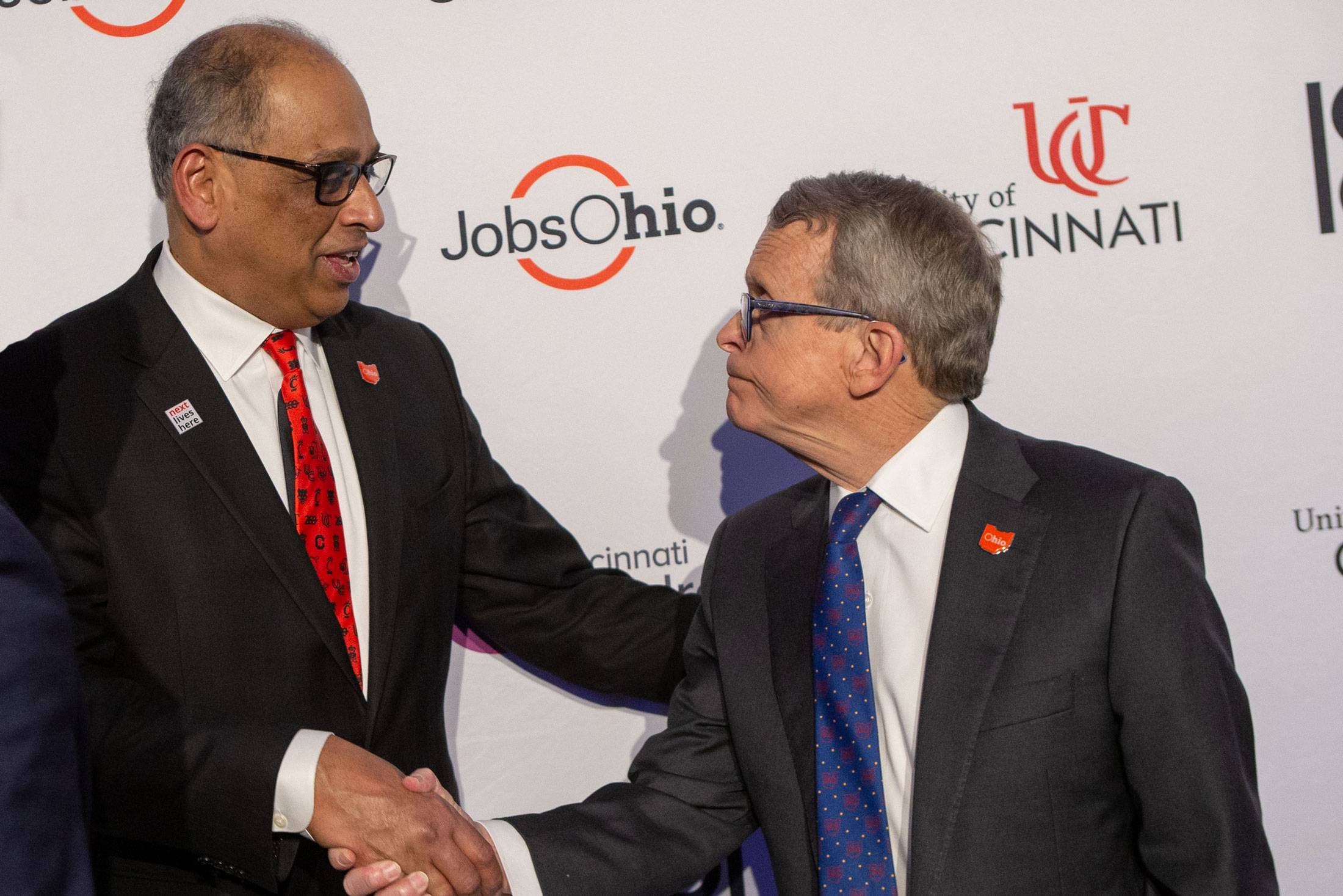 UC President Neville Pinto shakes hands with Ohio Governor Mike Dewine