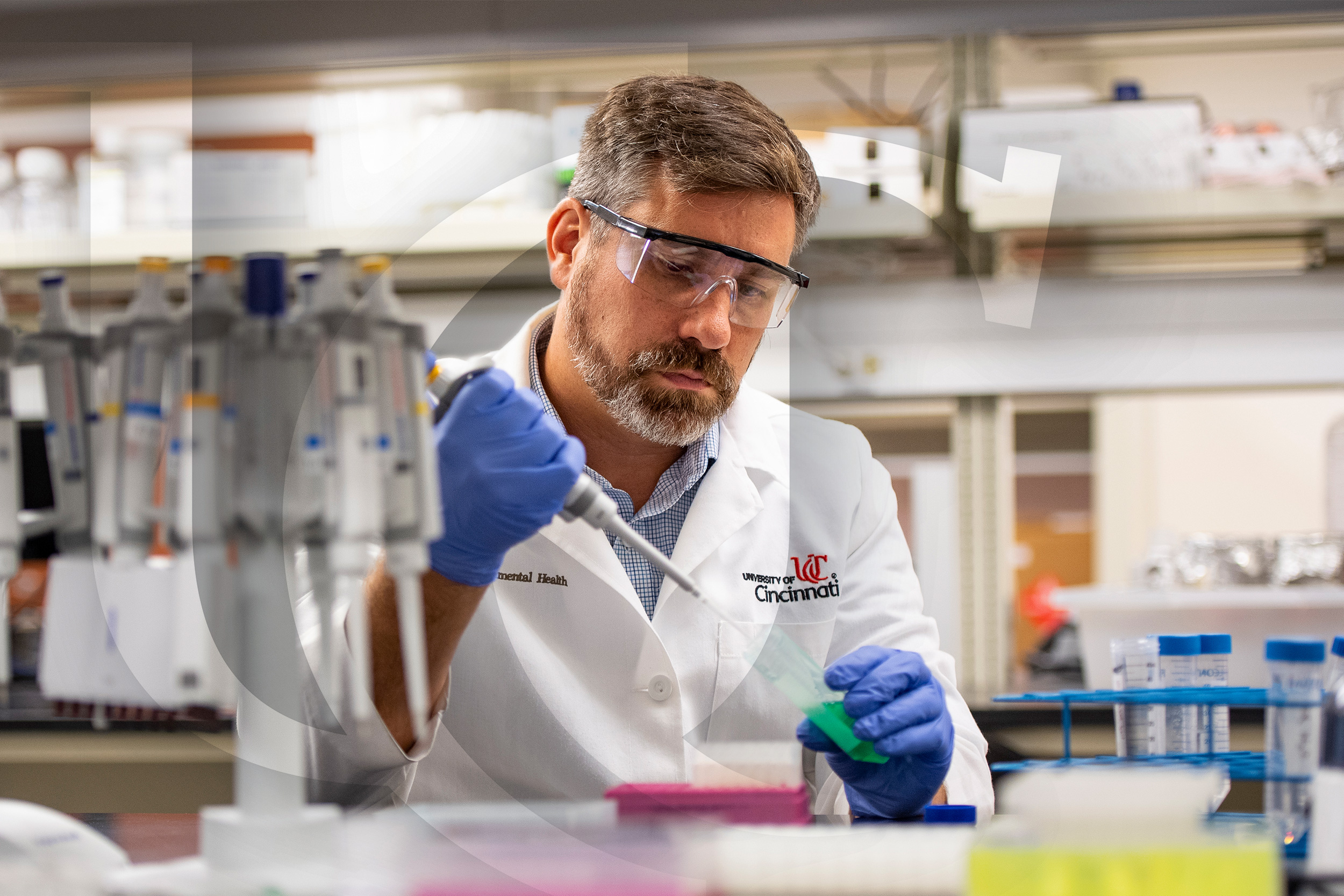 A UC researcher works in a lab