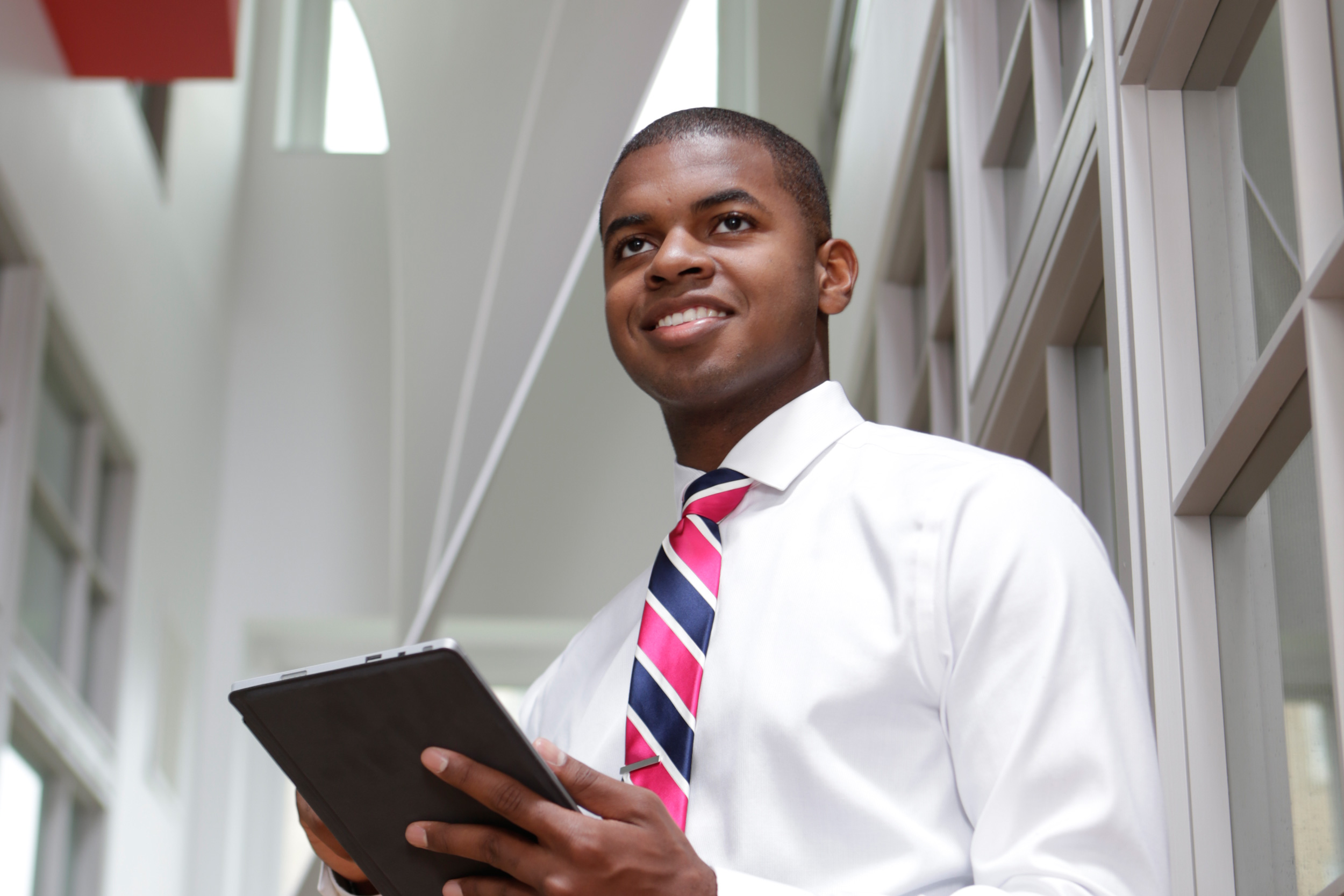 A UC co-op student looks up from his tablet