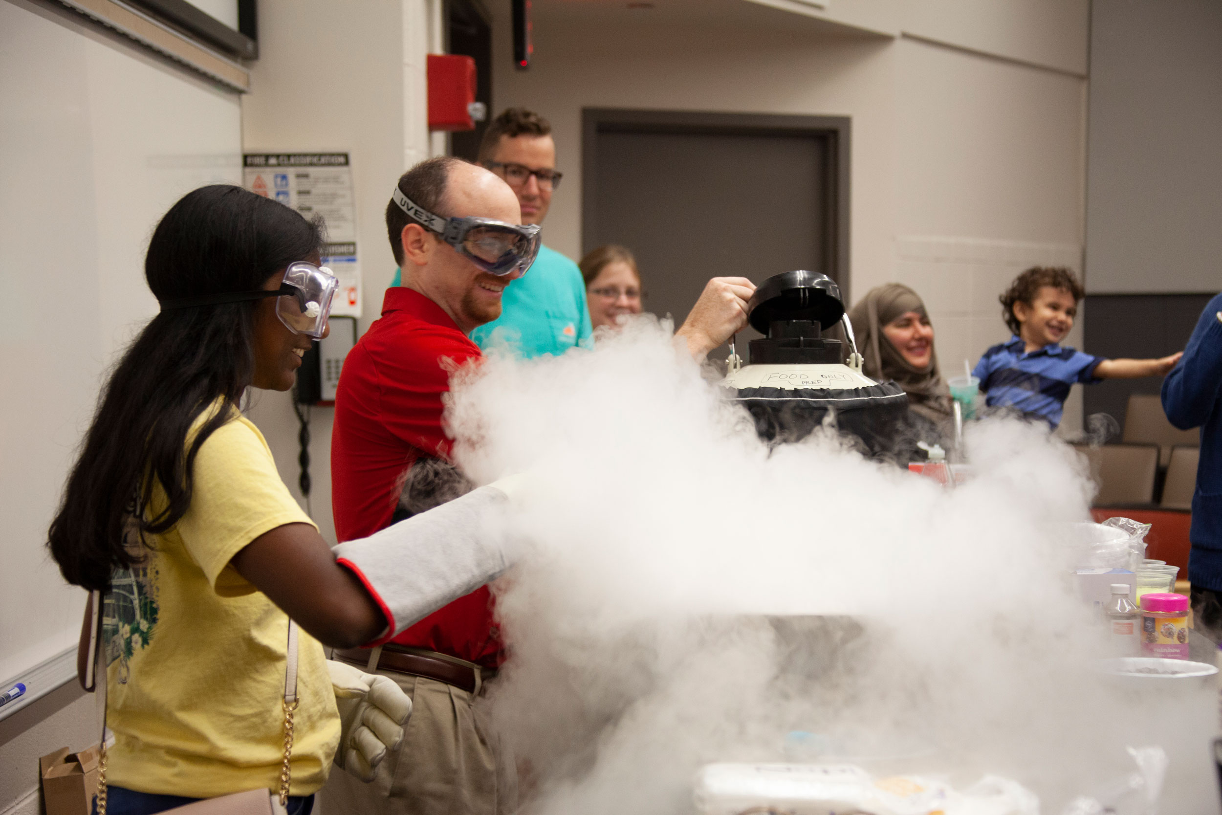 A student and a professor conduct an experiment in a lab