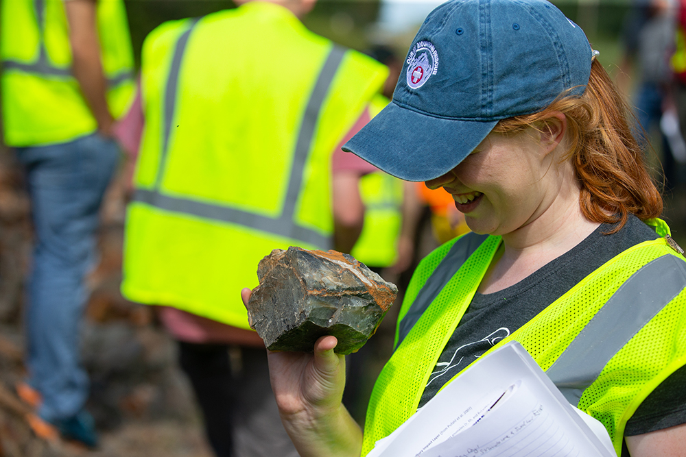 A University of Cincinnati Geology student examines a rock