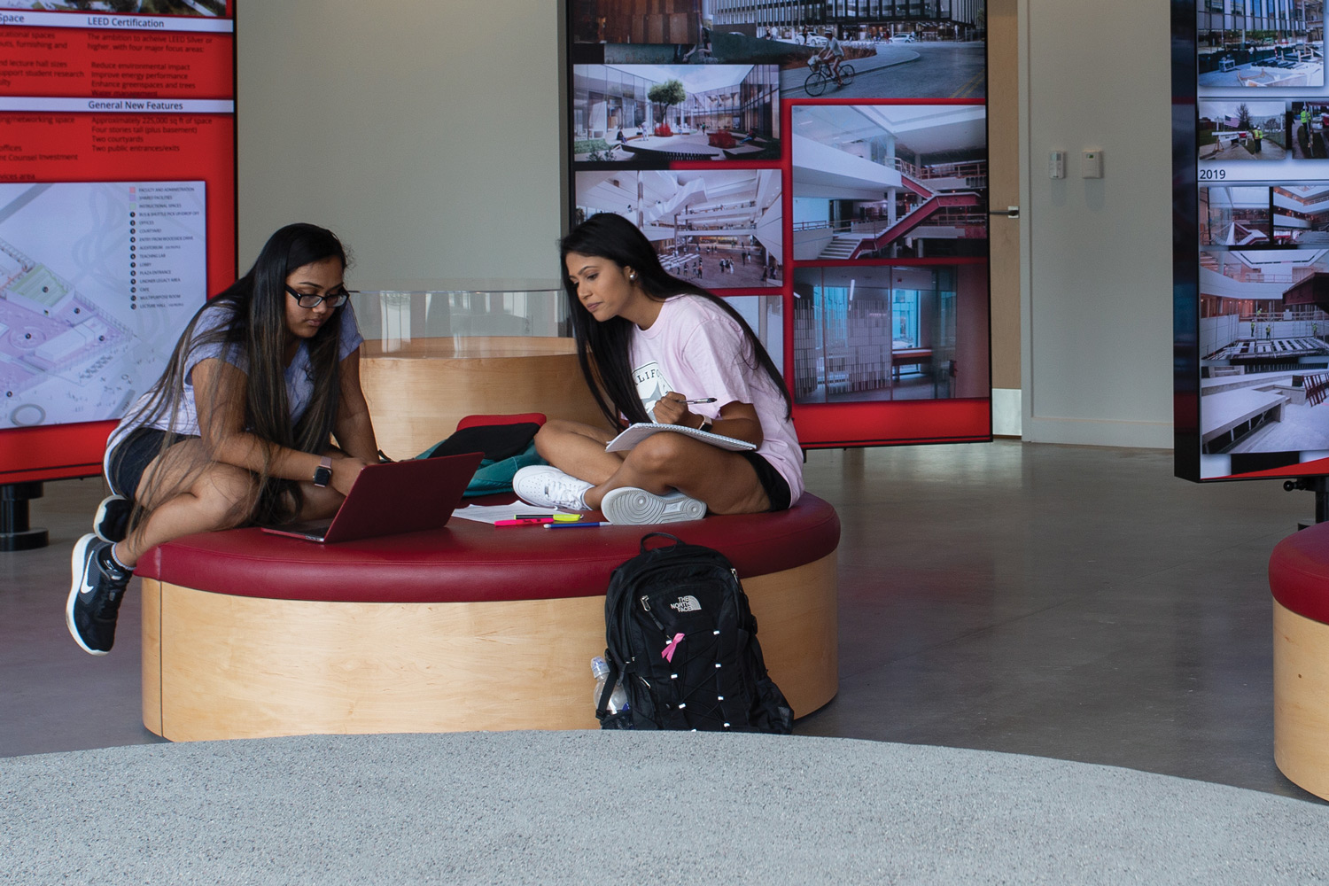 Students converse in the lobby of the all new Lindner College of Business