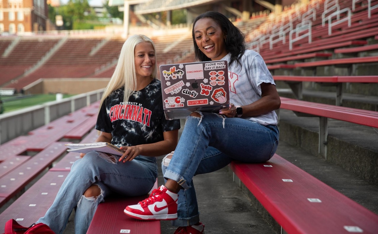 Communications major Gabby Mullins at Nippert Stadium with friend Mya Cook.