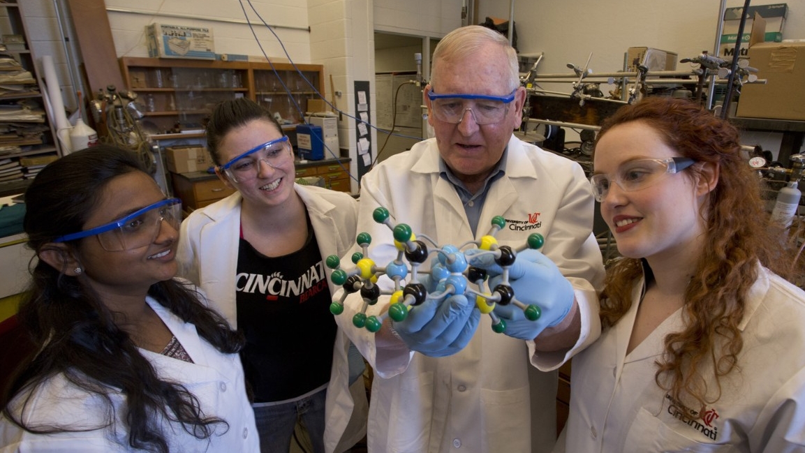 UC Chemistry students investigate a molecular model with a professor