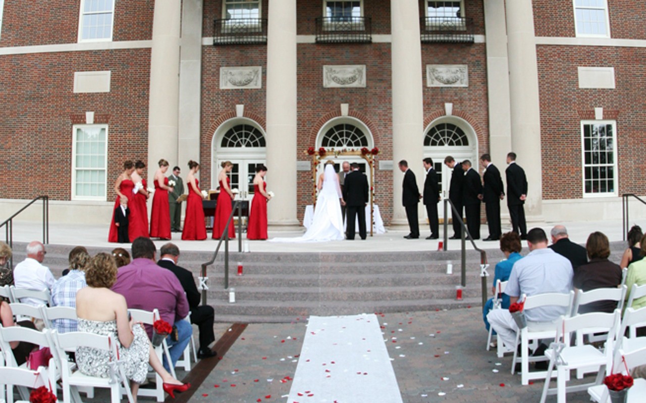 Wedding ceremony on the steps to Tangemean University Center, with guests seated on the plaza.