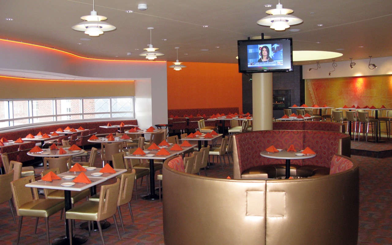 Restaurant seating with tables and chairs, as well as booths