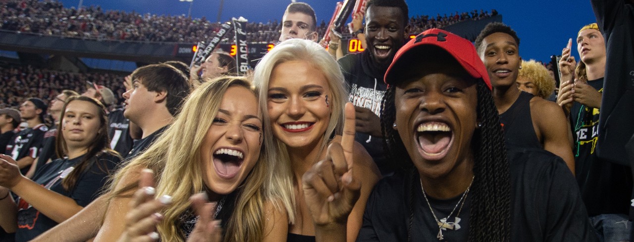 UC students cheering during a home football game