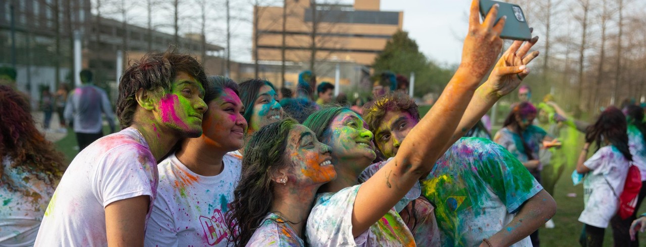 International students sit together on a bench.