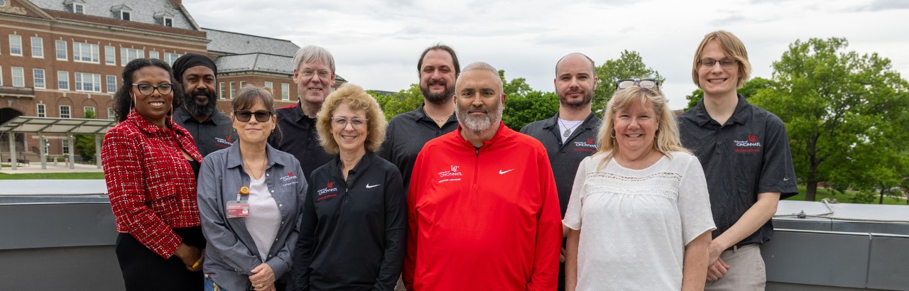 Team photo outside on a balcony