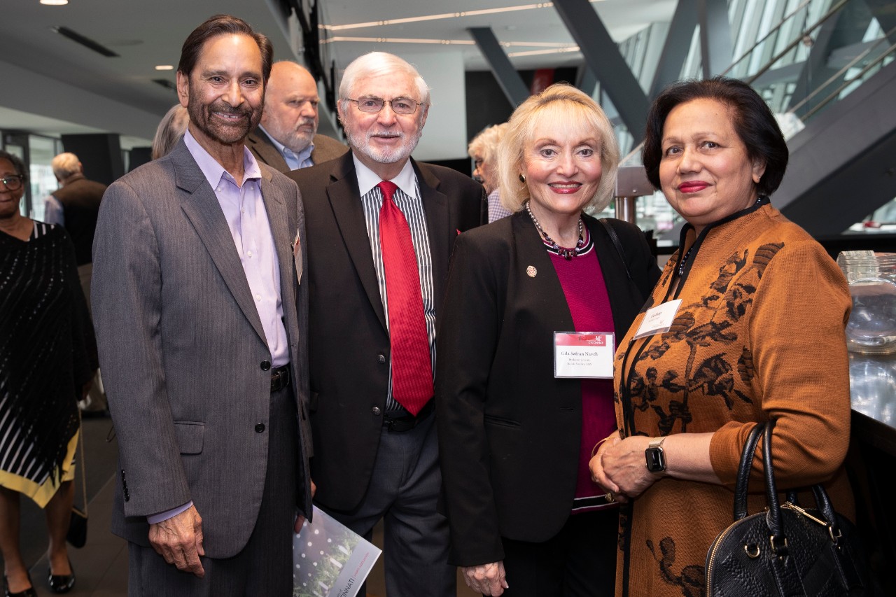 Four members of the Emeriti Association smiling at the camera at the 2022 annual luncheon 