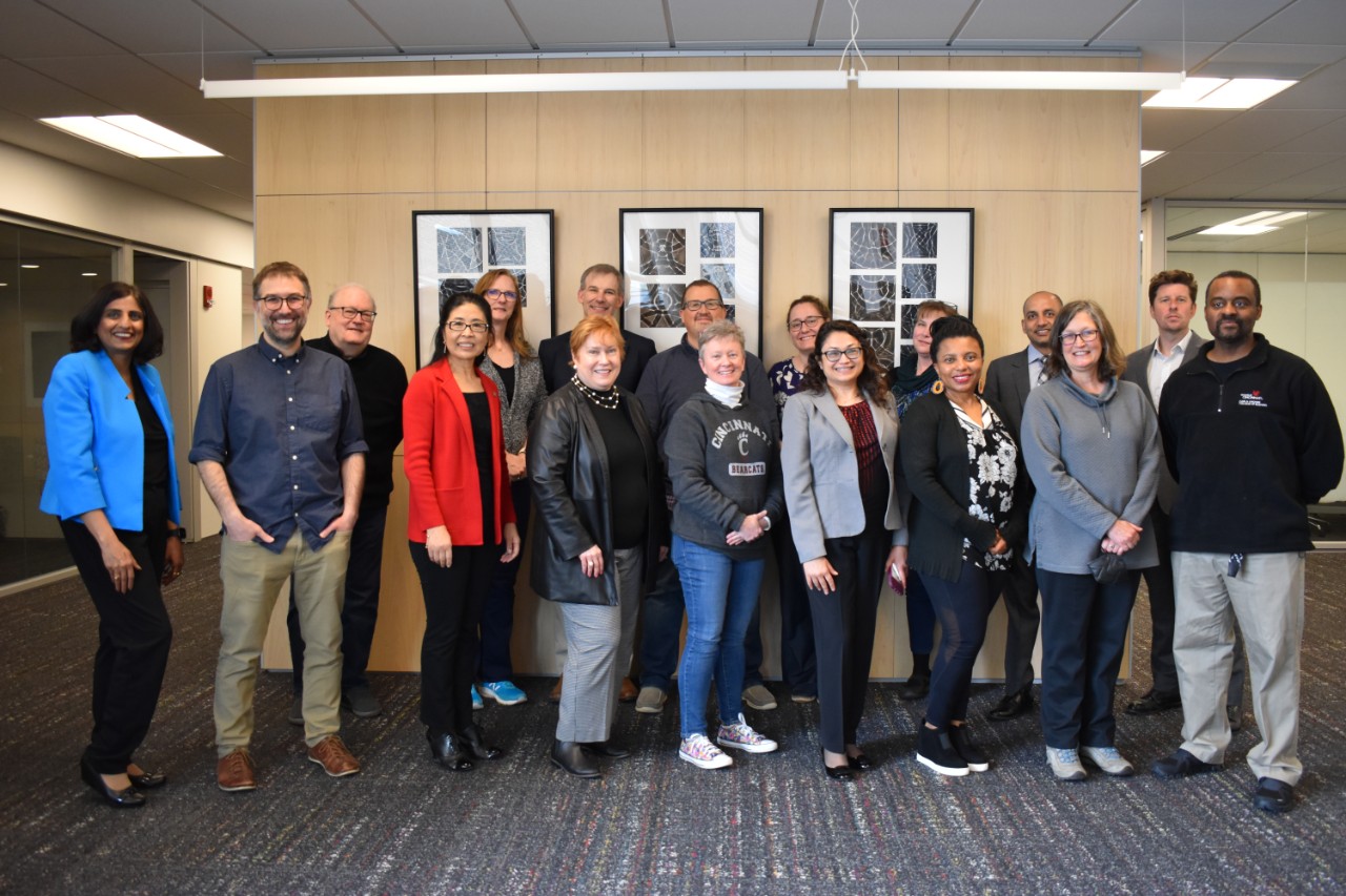 people of various gender and nationalities holding hands