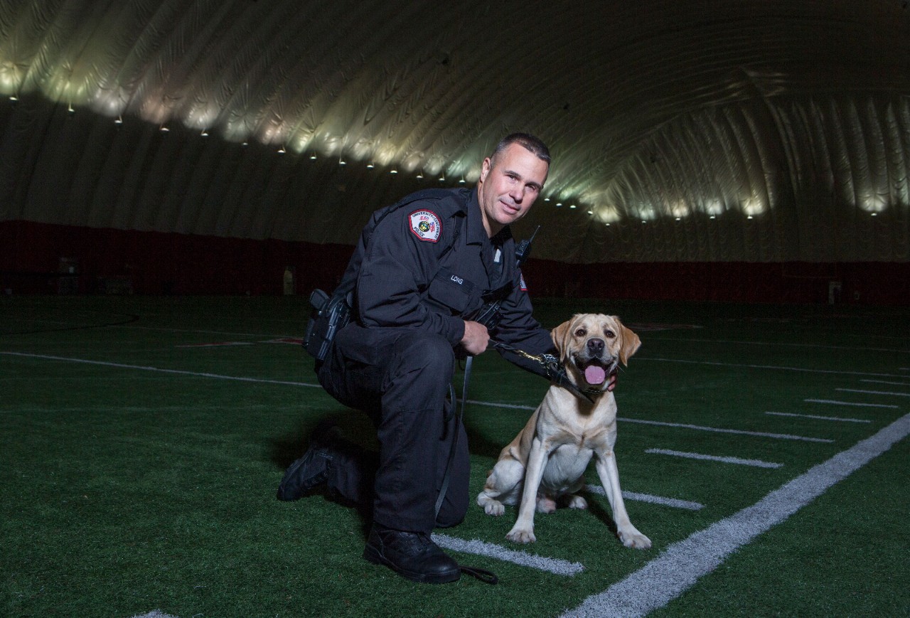 Officer Lance Long poses with K-9 Dozer.