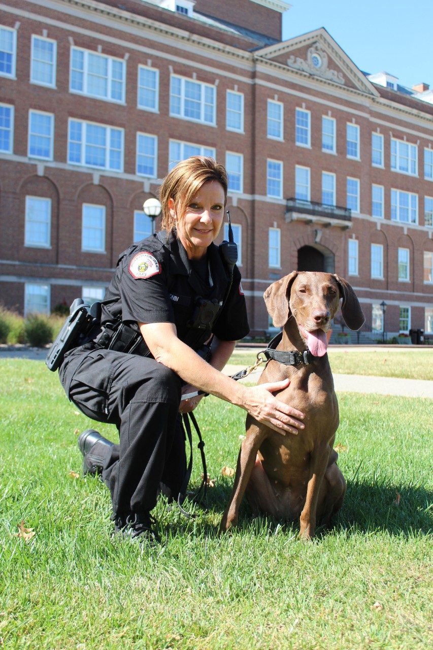 Officer Lori Cronin poses with K-9 Harley.