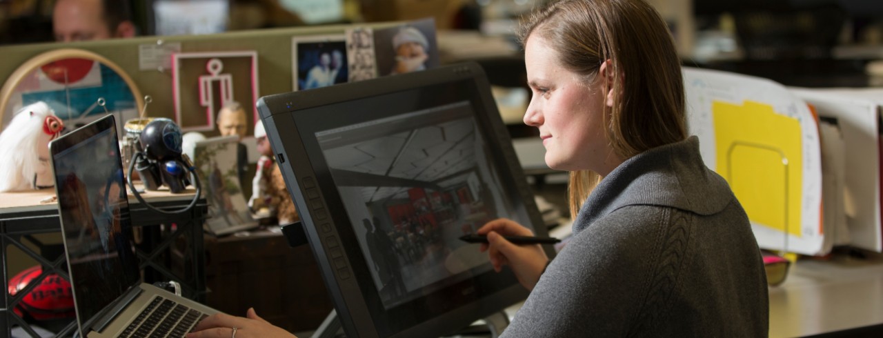 UC student sitting at a computer 