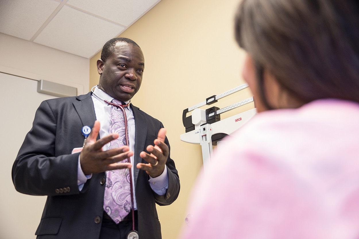 Dr. Olowokure Olugbenga at the the UC Barrett cancer center with patient.