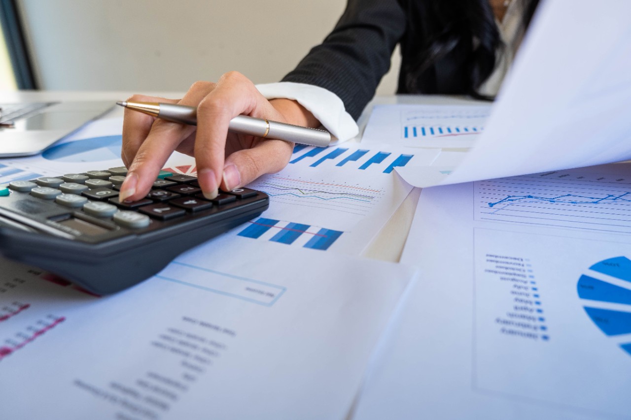 A student calculating their student loan interest on a calculator