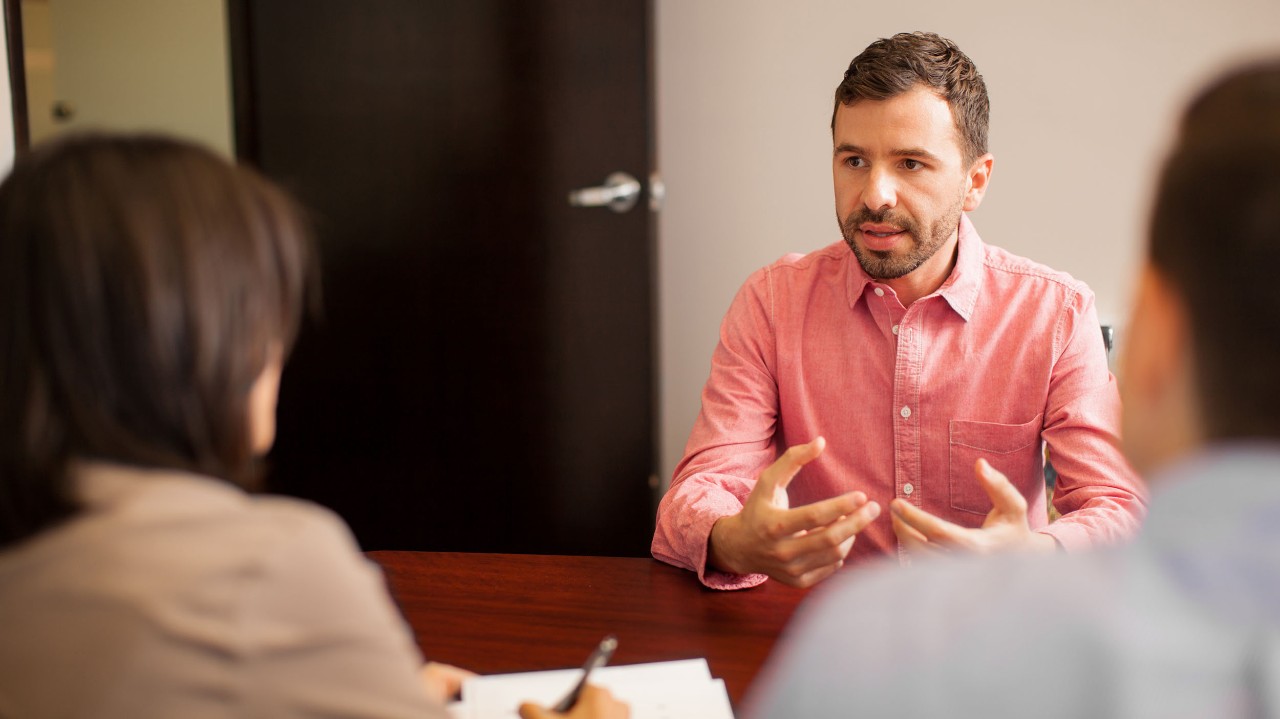 Young man sitting in a grad school interview