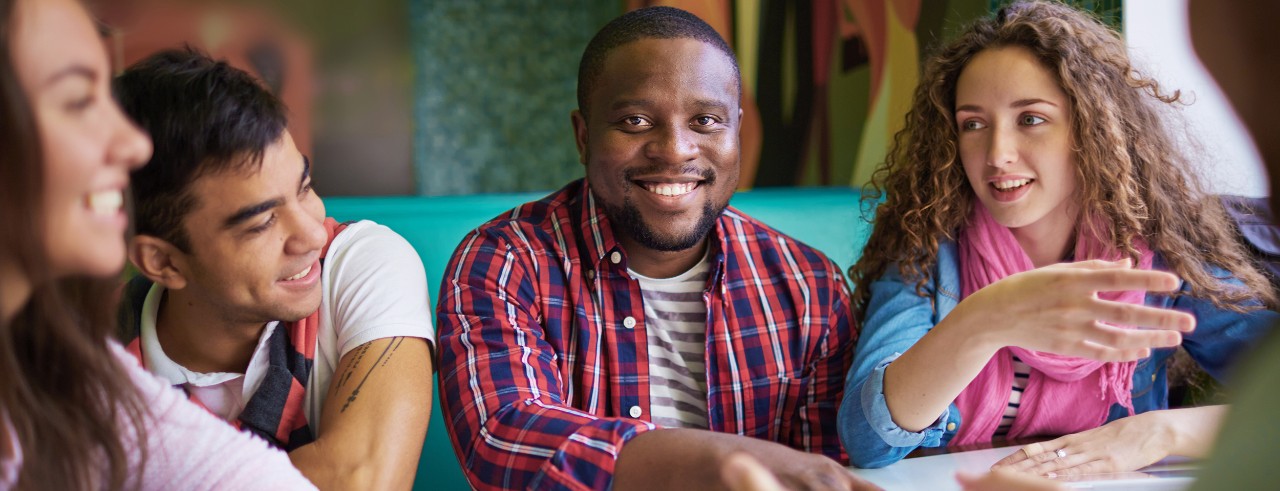UC students sitting together talking about the college experience