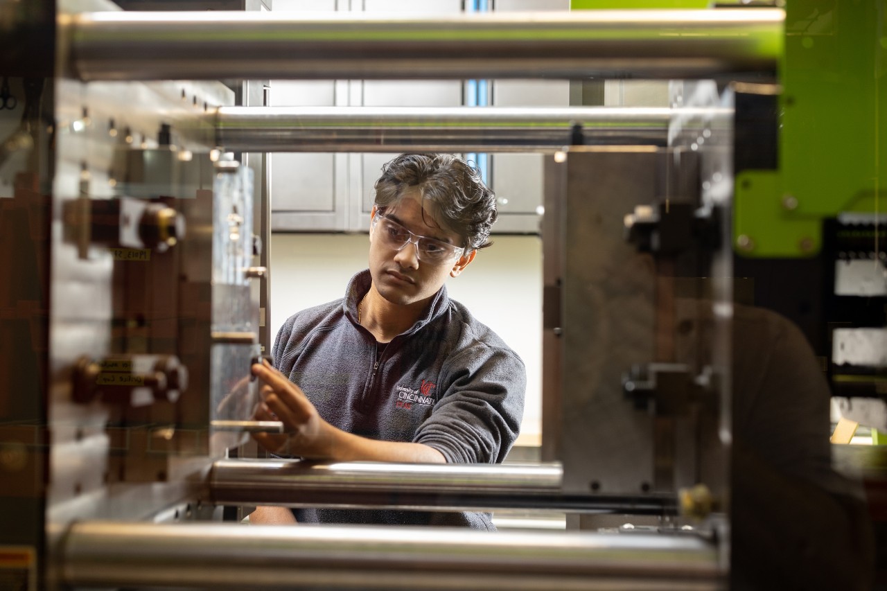Student on co-op using machinery. Studying engineering and getting co-op experience are great ways to boost ROI in college.