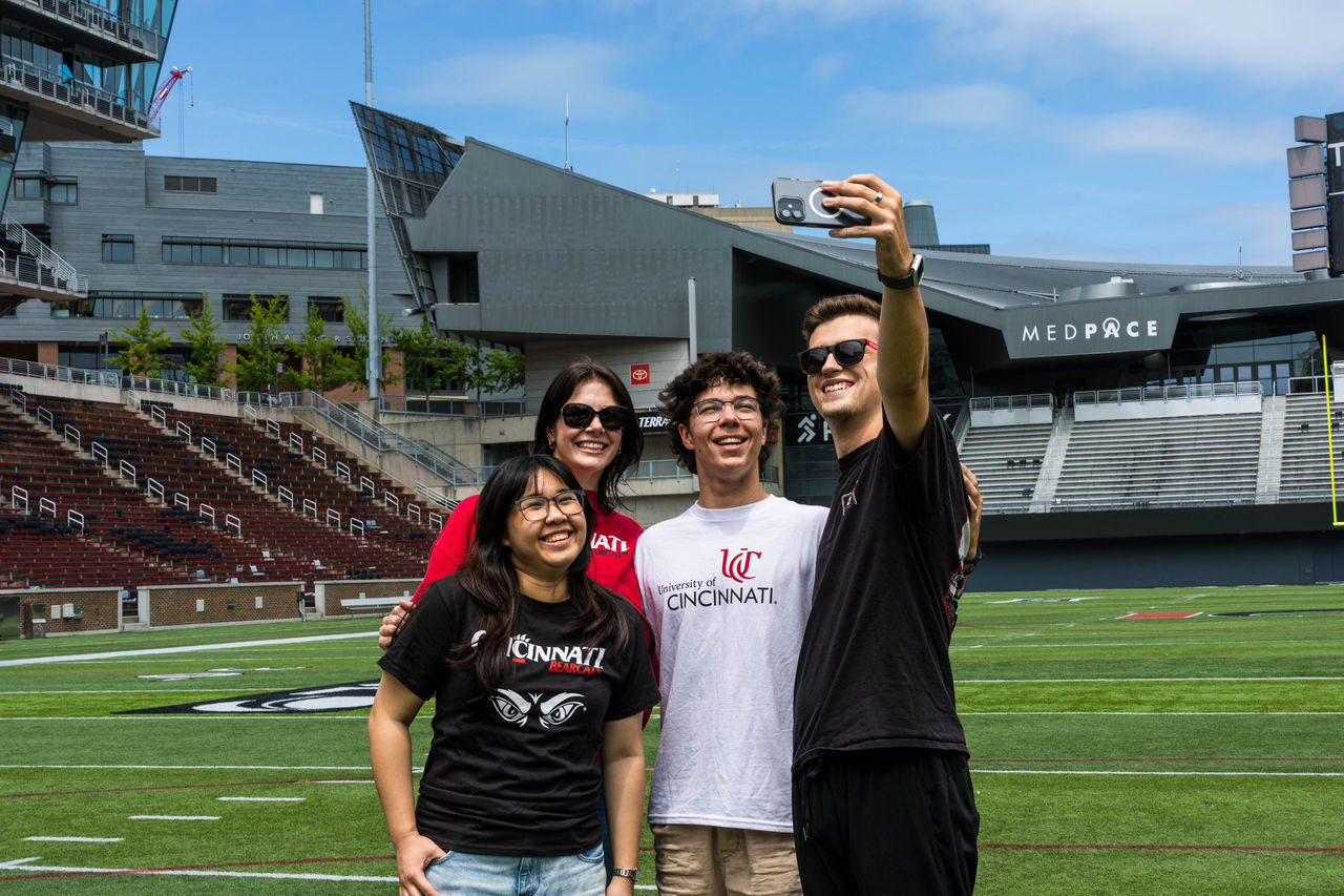 Students take a selfie in Nippert Stadium at UC, a big campus with a small-town feel
