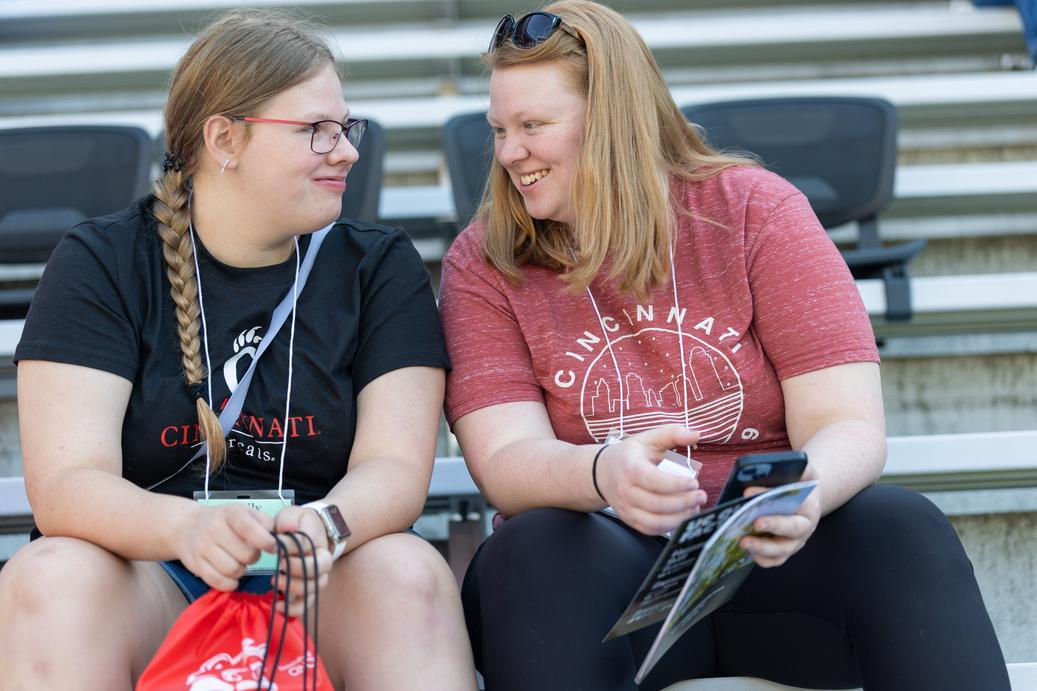 How much should parents pay for college? This mother and daughter smile, seated, talking to one another.