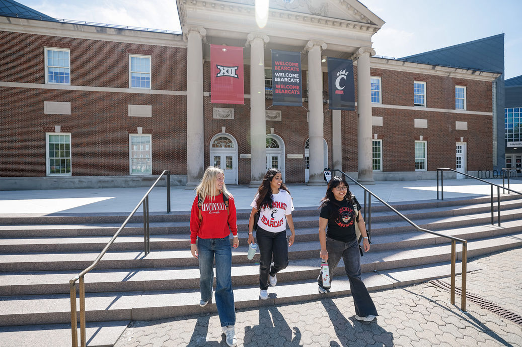 Three students walking on a sunny UC campus sharing freshman year college tips