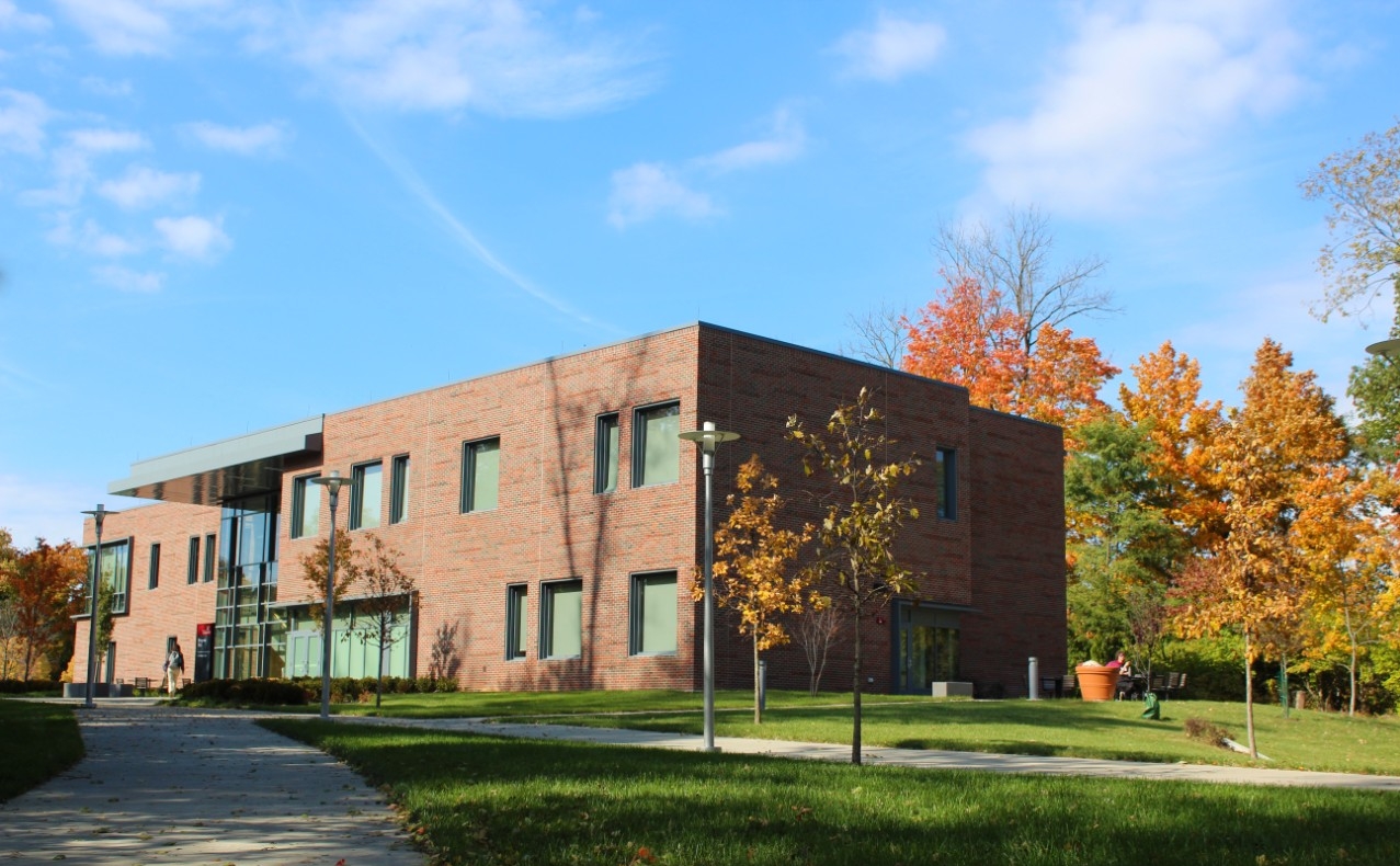 UC's Bearcat mascot cheers with two cheerleaders