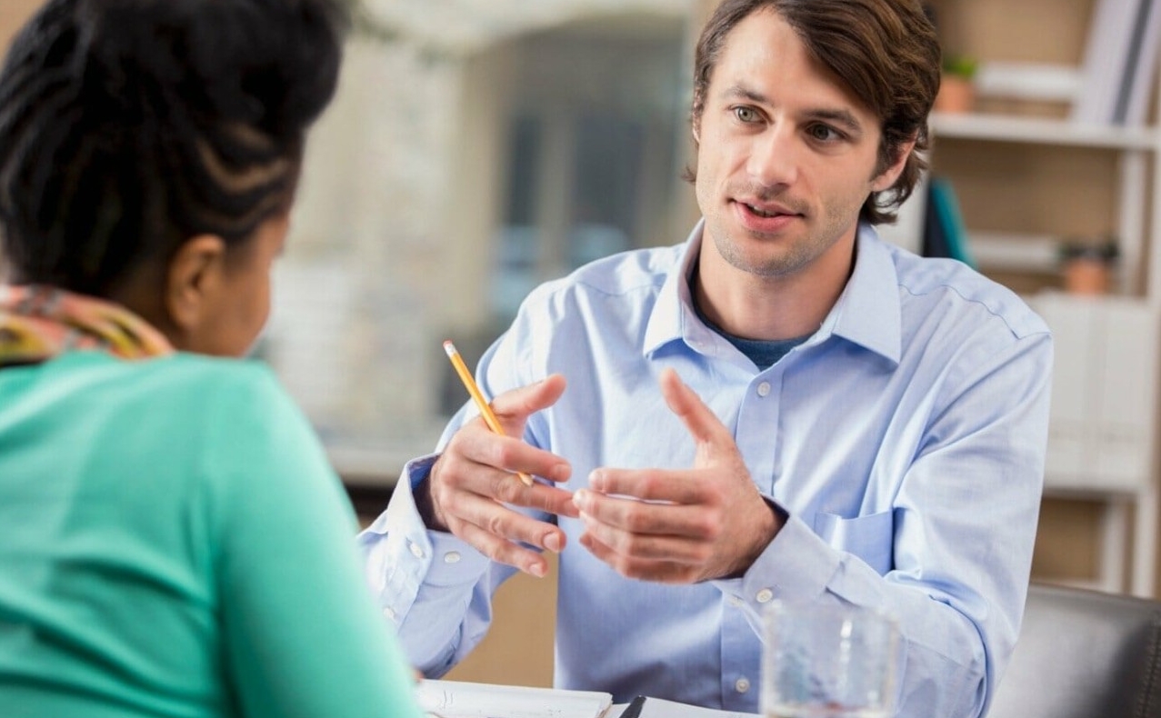 Two University of Cincinnati students work on a laptop as they sit in Nippert Stadium