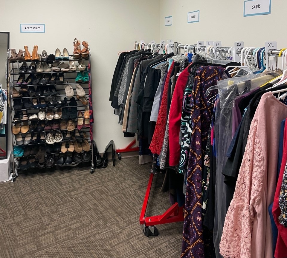 Racks of clothing and shoes organized for browsing by students. 