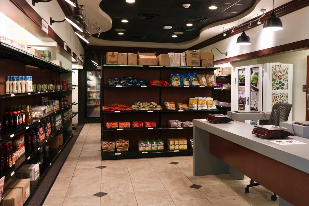 A view into the Bearcats Pantry entrance showing racks of food on shelving in the back.