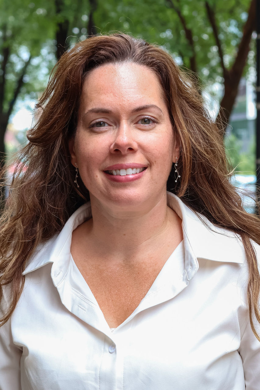 Brenda smiling outside of CAPS building.