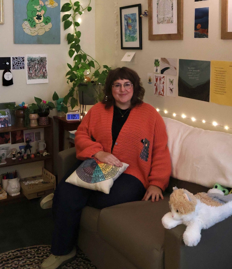 Photograph of Keysha Alston smiling inside her office. She is wearing glasses and a peach colored sweater.