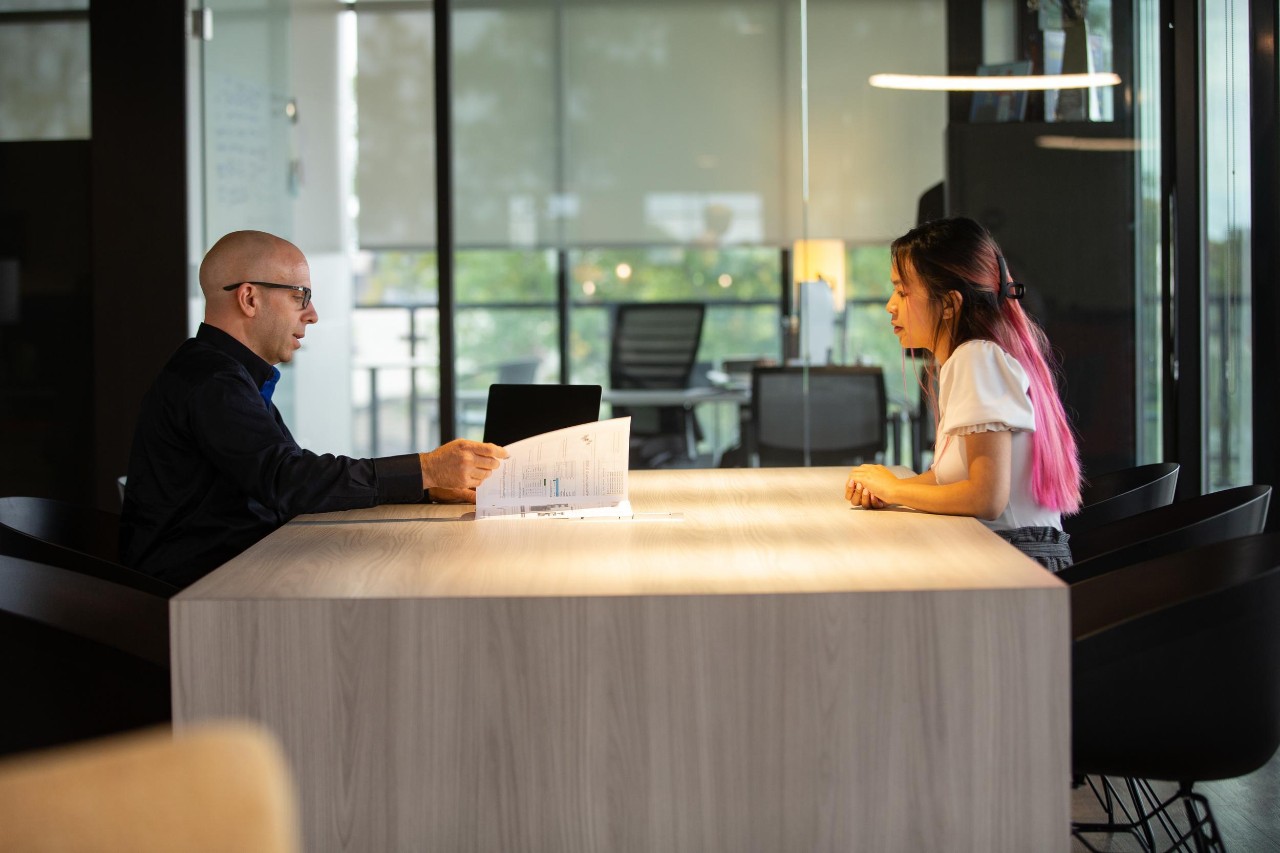 A UC co-op student meets with an employee from Kinetic Vision