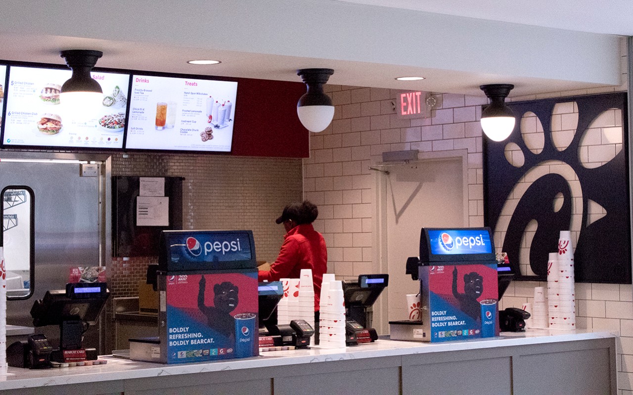 A worker behind the counter at Chick-fil-A walk-up ordering.