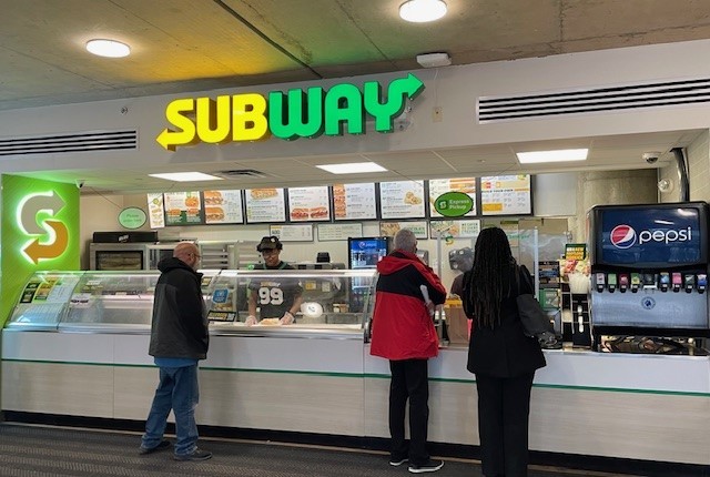 Customers order at a Subway sandwich shop on the UC medical campus.