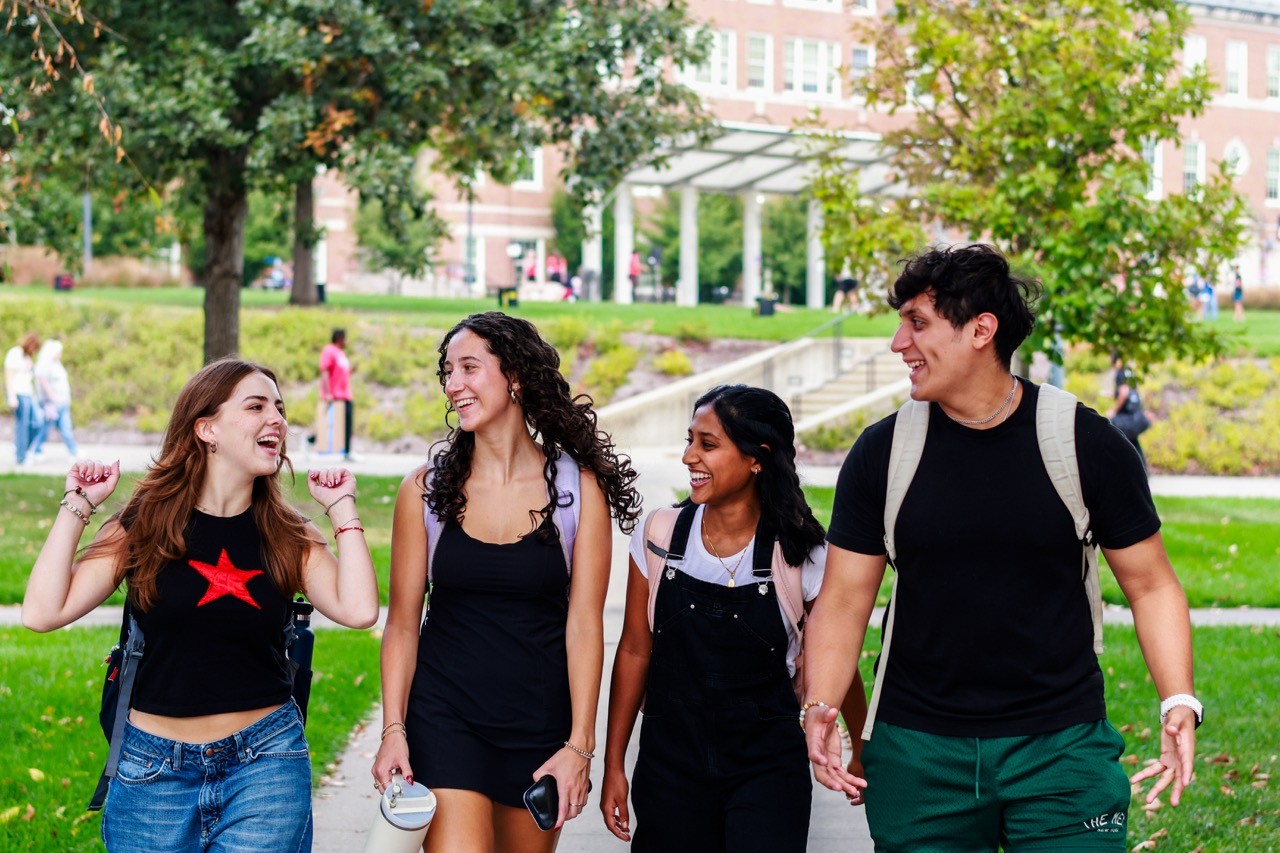 UHP students walking on campus talking and smiling